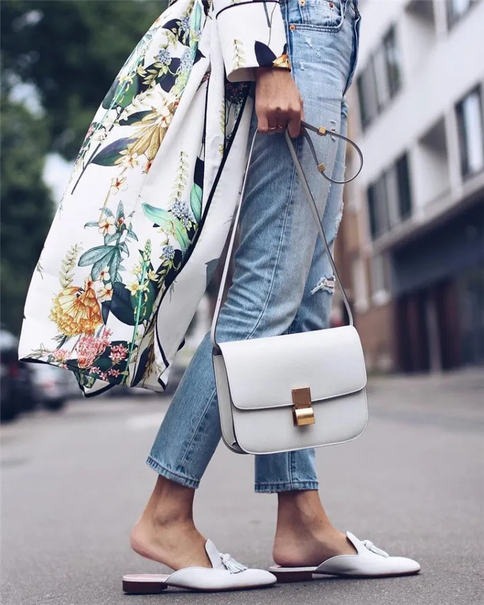 Светлые мюли с кисточками, джинсы, тренч с цветочным принтом и белая сумка — приятный освежающий аутфит.
