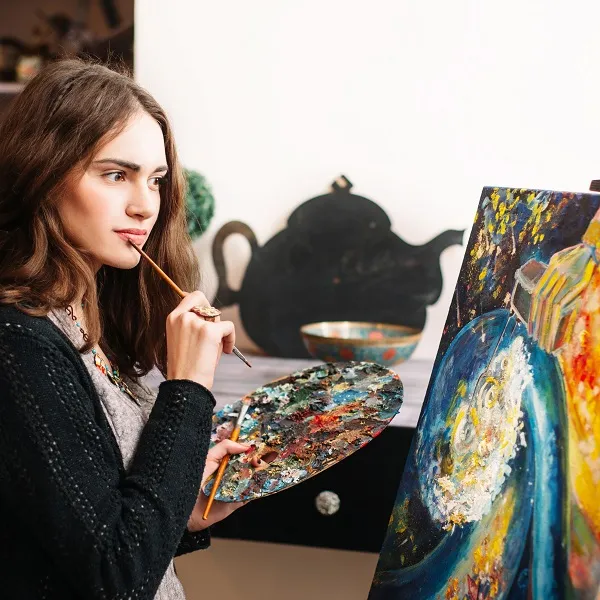 Женщина рисует картину.
