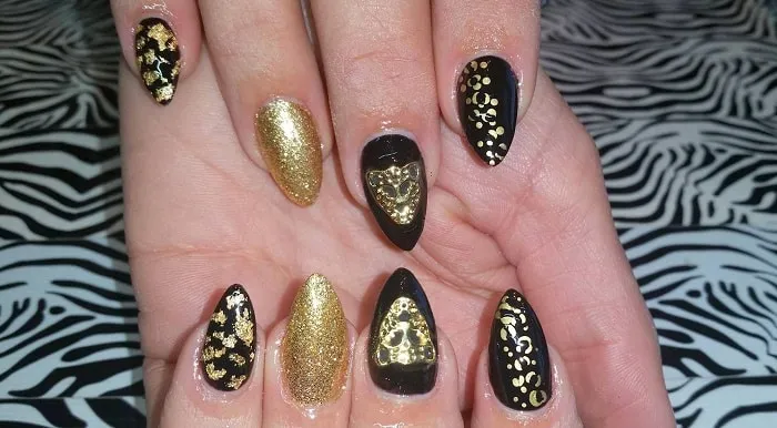 Черный дизайн ногтей с золотистыми вставками