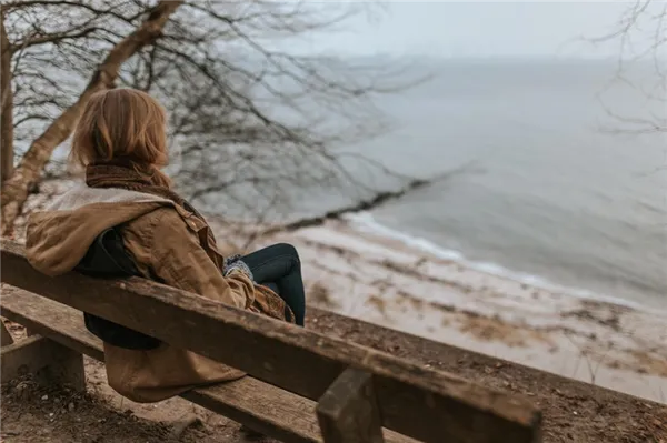 Женщина сидит на берегу моря